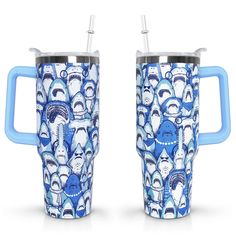 two blue and white mugs with faces on them, one has a straw in it