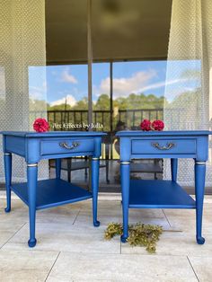 two blue end tables with flowers on them