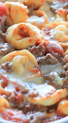 a close up of a pasta dish with meat and cheese