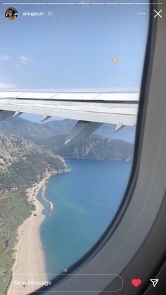 an airplane window looking out at the ocean