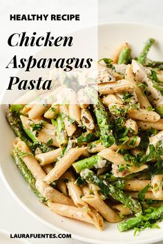 pasta with chicken and asparagus in a white bowl