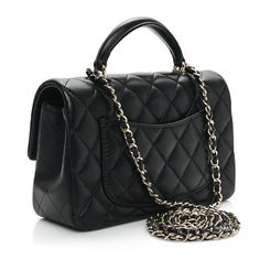 This is an authentic CHANEL Lambskin Quilted Mini Top Handle Rectangular Flap in Black. This chic mini cross body classic is crafted of quilted lambskin leather in black. The bag features a leather top handle, a gold chain link leather threaded shoulder strap and a facing gold Classic CC turn lock. This opens the flap to a black leather interior with zipper and patch pockets. Mini Cross, Mini Top, Leather Thread, Leather Interior, Lambskin Leather, Leather Top, Chain Link, Gold Chain, Patch Pocket