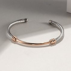 This stainless steel and gold PVD plated cuff bracelet features a chic cable design, offering a simple and sophisticated look. This piece of jewelry is sure to add style to your wardrobe. The stainless steel and gold plating make it long-lasting and low-maintenance, perfect for everyday use. Inner diameter 2.4"; Inner circumference 7" Rose Gold Cuff Bracelet, Brass Cuff Bracelet, Gold And Silver Bracelets, Cable Bracelets, Brass Cuff, Gold Fashion Necklace, Gold Bracelet Cuff, Silver Bangle Bracelets, Silver Cuff Bracelet