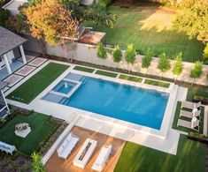 an aerial view of a backyard with a swimming pool