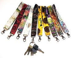 six lanyards with keys attached to them on a white background and one has a keychain in the middle