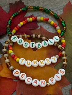 two beaded bracelets with words that spell out football and the word turkey on them