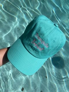 Tranquila y Tropical dad hat. Teal dad hat, light pink embroidered letters. 100% cotton, Adjustable closure. One size fits most. Trendy Cotton Hat For Vacation, Trendy Cotton Dad Hat For Vacation, Pink Curved Visor Hat For Summer, Pink Summer Baseball Cap Dad Hat, Spring Vacation Baseball Cap With Curved Bill, Beach Dad Hat With Embroidered Logo, Summer Embroidered Logo Baseball Cap, Trendy Dad Hat For Vacation And Spring, Pink Curved Brim Dad Hat For Summer