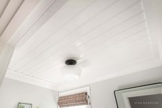 a bathroom with white walls and ceiling, toilet and sink in the corner next to window