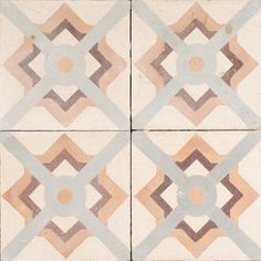 an old tile floor with geometric designs on the top and bottom tiles in different colors