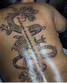 a woman with a dragon tattoo on her back