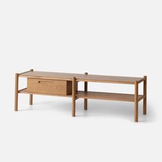 a wooden coffee table with two drawers on one side and an open drawer on the other