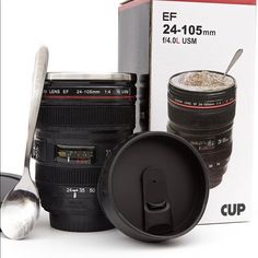 the coffee cup is next to two camera lens cups