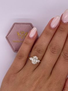 a close up of a person's hand with a ring on it