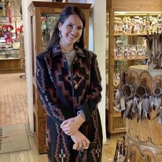 a woman standing in front of a store display