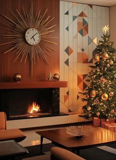 a living room with a christmas tree, fireplace and large clock on the wall above it