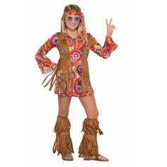 a woman in a hippie costume posing for the camera with her hand up and peace sign