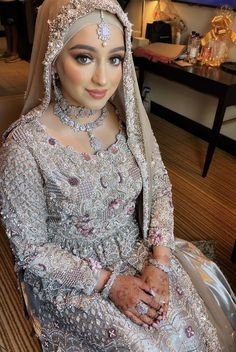 a woman in a wedding dress posing for the camera