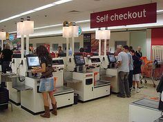 people are standing in line at the checkout counter