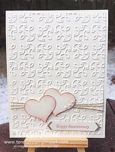 a card with two hearts on it and the words happy anniversary written in red ink