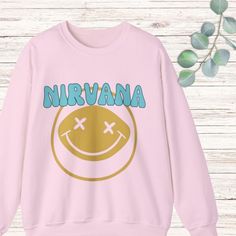 Elevate your wardrobe with this Nirvana Sweatshirt, featuring a retro vintage style. Adorned with the iconic Nirvana Smile Face, this pink sweatshirt seamlessly blends nostalgic vibes with a modern, trendy twist. Not only is it the perfect piece for every Nirvana fan, but with its preppy and aesthetic look, it's also a stylish addition to any outfit. Whether you're a rock enthusiast or just searching for that trendy sweatshirt to complement your collection, this is the ultimate pick. A brilliant gift idea, this rock band shirt captures the essence of the band while staying chic. Don't miss out on adding this Smile Face Shirt to your ensemble! .: 50% cotton, 50% polyester .: Medium-heavy fabric (8.0 oz/yd² (271.25 g/m .: Loose fit .: Sewn-in label .: Runs true to size Preppy And Aesthetic, Nirvana Crewneck, Pink Nirvana, Nirvana Smile, Nirvana Sweatshirt, Vintage Nirvana, Rock Band Shirts, Band Shirt, Aesthetic Look