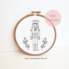 an embroidery pattern with a nutcracker wearing a crown