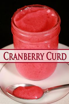 a jar of cranberry curd on a plate with a spoon