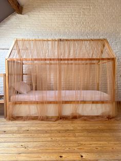 a bed that is sitting in the middle of a room with mosquito netting on it