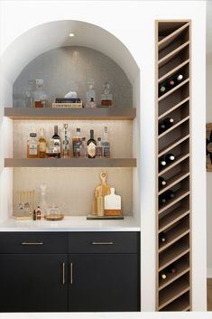 bar, wine, wine shelves, wine rack, dark cabinets, gold hardware, arch, wallpaper, wood shelves, lower level, white countertops, quartz countertops, recessed lighting, white trim, white paint Bar In Living Room, Cafe Industrial, Home Wine Bar, Home Bar Areas, Home Bar Designs