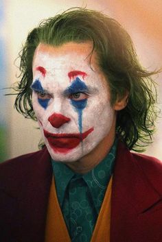 a close up of a person wearing clown makeup