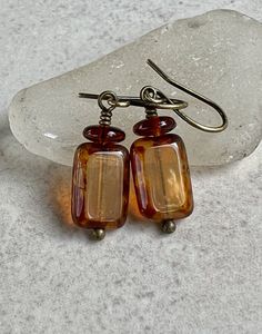 "small yellow brown earrings   rectangle czech glass earrings   brass boho dangle earrings * Czech glass rectangle beads - 8x12mm * transparent milky light yellow with heavy brown Picasso coating on edges * brown glass disc on top * antiqued brass hook ear wires * total length - 1 1/4\" * you can enter my shop here:    gypsydangles.etsy.com" Cheap Brown Earrings For Party, Cheap Traditional Brown Earrings, Minimalist Handmade Rectangular Jewelry, Rectangular Brown Jewelry For Gifts, Brown Rectangular Jewelry Gift, Rectangular Brown Jewelry As A Gift, Rectangular Brown Jewelry Gift, Bohemian Rectangular Ear Wire Earrings, Bohemian Rectangular Earrings With Ear Wire