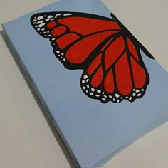 a painting of a red butterfly on a blue background