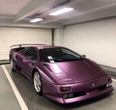 a purple sports car parked in a parking garage