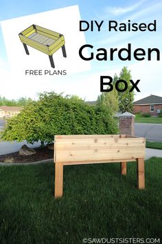 the diy raised garden box is sitting in the grass next to a tree and bushes