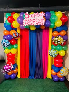 the balloon arch is decorated with balloons and streamers