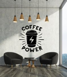 there is a coffee power wall decal in the living room with two chairs and a table