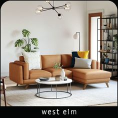 a living room filled with furniture and a white rug on top of a hard wood floor