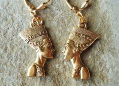 "Fascination with ancient Egyptian artifacts profoundly influenced archaeology and popular culture. This is a statement earrings. This striking earrings features a sculpted Egyptian queen Nefertiti, goddess is sculpted on both side. Metal made of pewter and plated in 24 karat gold. Hanging from a surgical steel lever-back, it measures 1.75 \" in length.  Earrings are light weight and sway gracefully as you move about your day.  These stunning dangle earrings are unique and eye-catching, a great Goddess Egyptian, Nefertiti Earrings, Egyptian Princess, Ancient Egyptian Artifacts, Egypt Jewelry, Egyptian Queen Nefertiti, Art Statement, Ancient Goddesses, Egyptian Artifacts