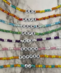 the beads are all different colors and have letters that spell out their names on them