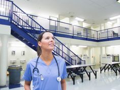 a nurse standing in front of a set of stairs