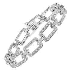 Indulge in the ultimate luxury with our stunning 14K White Gold Diamond Open Paperclip Link Tennis Bracelet. This exquisite piece boasts a total diamond weight of 3/4 carats, with 144 natural round diamonds set in a pave setting. The H-I color and I2-I3 clarity of the diamonds ensure a brilliant sparkle that will capture everyone's attention. The pave diamond paperclip design link bracelet is both fashionable and timeless, making it perfect for any occasion. The box clasp ensures a secure and co Luxury White Gold Paperclip Bracelet For Formal Occasions, Bracelet Tennis, Round Diamond Setting, Modern Bracelets, Gold Link Bracelet, Diamond Tennis Bracelet, White Gold Bracelet, Pave Setting, Trombone