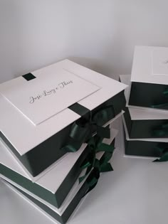 three boxes with green bows on them are stacked next to each other and the box is empty