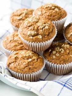 several muffins sitting on top of a blue and white cloth next to each other