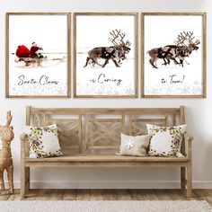 three framed art prints on a white wall above a wooden bench in a living room