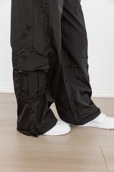 These Urban Glide Parachute Pants provide a comfortable and stylish fit for any urban adventurer. The lightweight, durable fabric allows for maximum movement and breathability, perfect for exploring the city. With a modern design and functional features, these pants are a must-have for any fashion-forward individual. Techwear Parachute Pants For Outdoor Activities, Techwear Baggy Parachute Pants For Outdoor, Baggy Techwear Parachute Pants For Outdoor, Urban Cargo Pants With Functional Pockets For Streetwear, Techwear Parachute Pants With Functional Pockets For Outdoor Activities, Urban Bottoms With Functional Pockets For Streetwear, Urban Streetwear Bottoms With Functional Pockets, Urban Style Baggy Bottoms For Outdoor Activities, Urban Style Baggy Parachute Pants For Outdoor