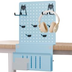 a pair of headphones hanging on a pegboard with ear phones attached to it