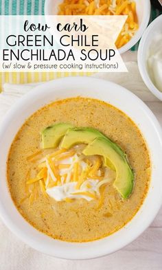 a bowl of green chile enchilada soup with cheese and avocado