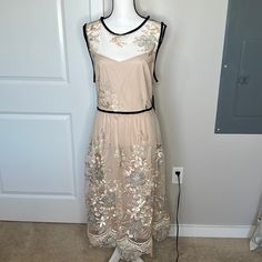 Nwt Julia Jordan Cocktail Dress. Beautiful Sleeveless Nude Dress With Embroidered Flowers- Rose Gold, Champagne And Bronze Shimmer. Bottom Is Lace, Top Is Black Velvet Trim. Button And Hidden Zipper Closure. Has Extra Button. Fully Lined. Size 16w. Body Is 100% Nylon, Lining Is 100% Polyester. Approximate Measurements- Armpit To Armpit- 23 1/2 Inches, Waist- 19 1/2 Inches, Hips- 25 Inches, Length- 46 Inches. Beige Sleeveless Dress For Cocktail In Spring, Beige Sleeveless Dress For Spring Cocktail, Sleeveless Cream Midi Dress For Casual Wear, Cream Sleeveless Midi Dress For Casual Occasions, Beige Sleeveless Dress For Spring Wedding, Spring Wedding Sleeveless Beige Dress, Jordan Dress, Boston Proper Dresses, White Sheath Dress