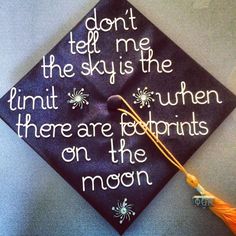 a graduation cap with the words don't tell me the sky is the limit there are footprints on the moon