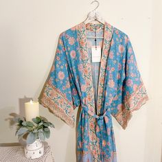 A Romantic Midi Robe By Spell. Crafted In Luxurious Cotton With A Vibrant Bohemian Print And Wide Kimono Sleeves. Detachable Tie Waist Belt Included. Side Splits And Midi Length. Condition: Brand New (With Tag) - No Defects Or Flaws Color: Blue Contents: 100% Organic Cotton Tags: Free People Kimono, Free People Floral Kimono, Bohemian Kimono, Bohemian Floral Kimono Elegant Blue Kimono For Vacation, Elegant Blue Floral Print Kimono, Elegant Blue Beach Kimono, Vintage Floral Print Kimono For Wedding, Blue Silk Kimono For Wedding, Fitted Blue Bohemian Kimono, Blue Silk Wedding Kimono, Bohemian Wedding Robe With Kimono Sleeves, Elegant Blue Wedding Robe