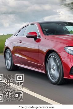 a red mercedes benz coupe driving down the road